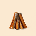 Split pecan firewood logs, stacked on a cream studio background