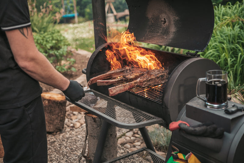 Offset smoker burning cooking wood